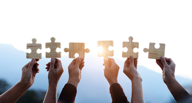 hands holding up puzzle pieces