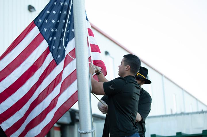 men raising the US flag