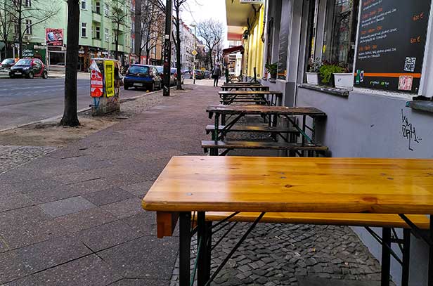 Deserted outdoor chairs and tables from a street restaurant in Friedrichshain