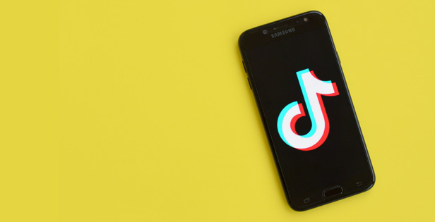 iPhone with TikTok logo on screen