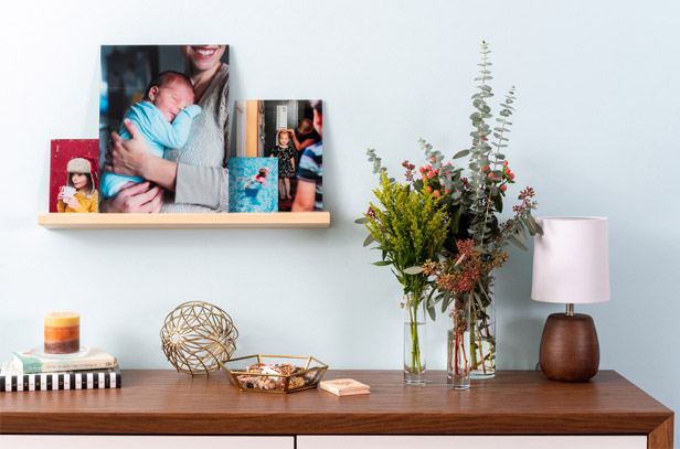 Canvas prints on shelf above desk