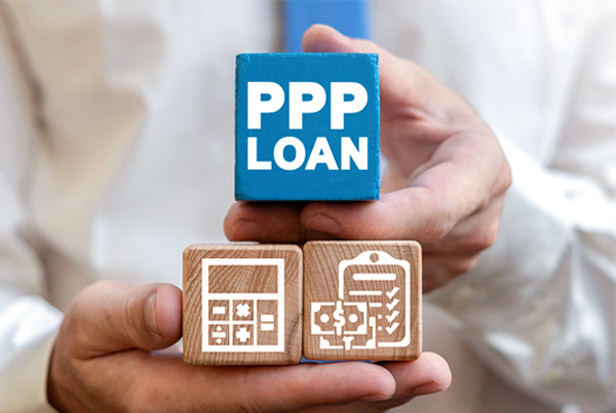 Hands holding PPP loan blocks