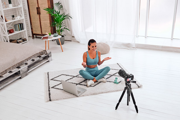 Woman sitting on floor doing live stream video