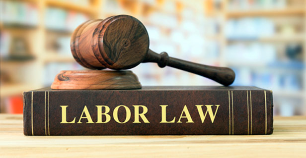 labor law book with gavel resting on top