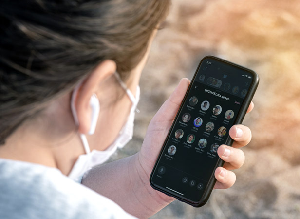 Woman looking at Spaces app on iPhone