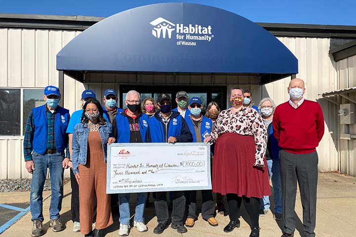 Maple Ridge Farms representatives that included Executive VP Jodie Schillinger, President Tom Riordan and Shana Gardner, one of the main architects of the company’s “Give Back” program, present a donation to Habitat for Humanity of Wausau.