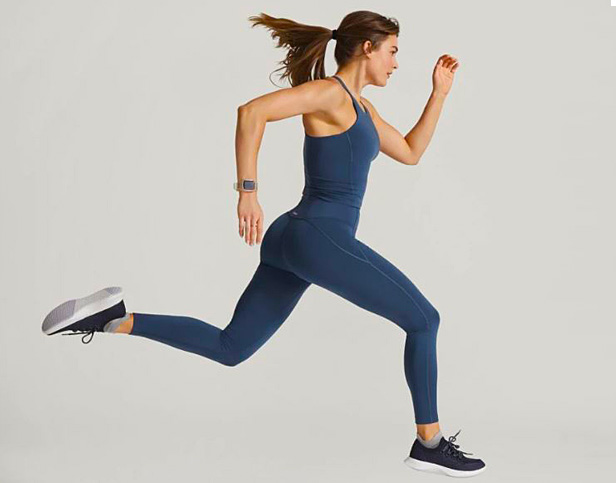 Woman running in blue leggings and tank
