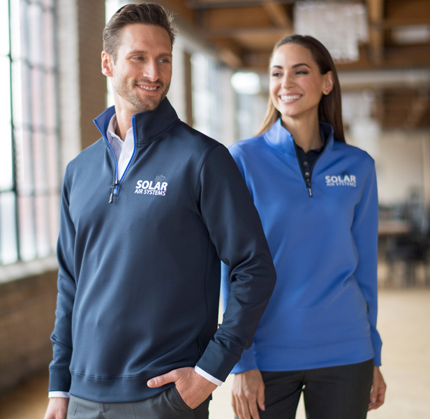 Man and woman wearing blue quarter-zip pullovers