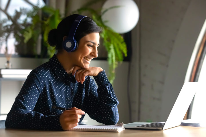 Woman smiling at open laptop