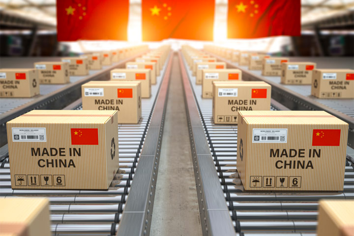 Chinese boxes on conveyor belt with flags in background