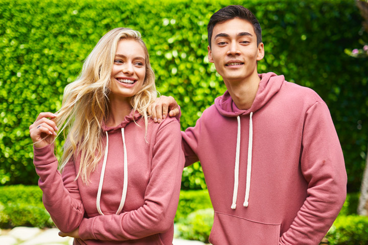 woman and man wearing matching mauve hoodies