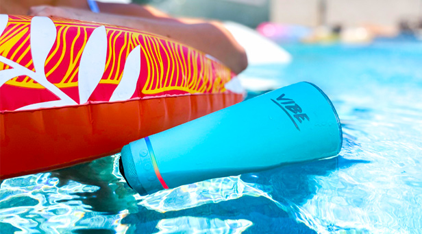 blue stainless steel tumbler/speaker floating in pool