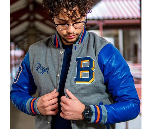 man wearing blue leather and wool varsity jacket