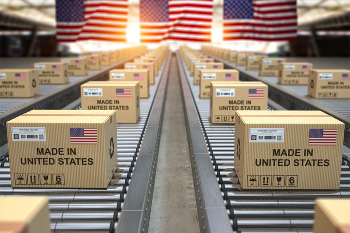 USA cardboard boxes on conveyor belt with US flags in background
