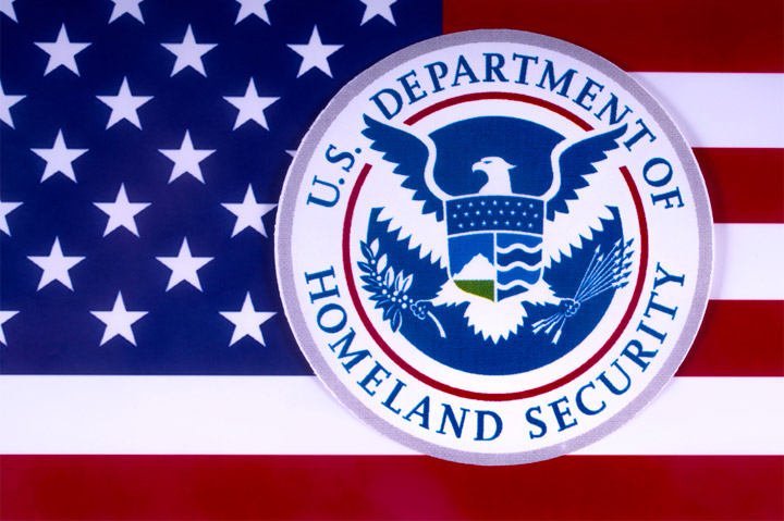 U.S. Department of Homeland Security emblem against U.S. flag