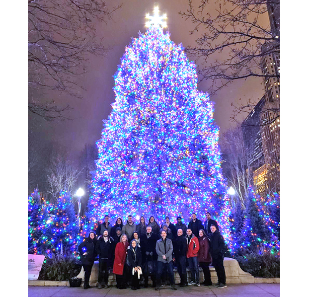 iPromo staff in front of large Christmas tree