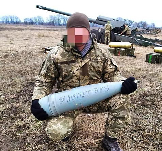 Ukrainian soldier holding shell
