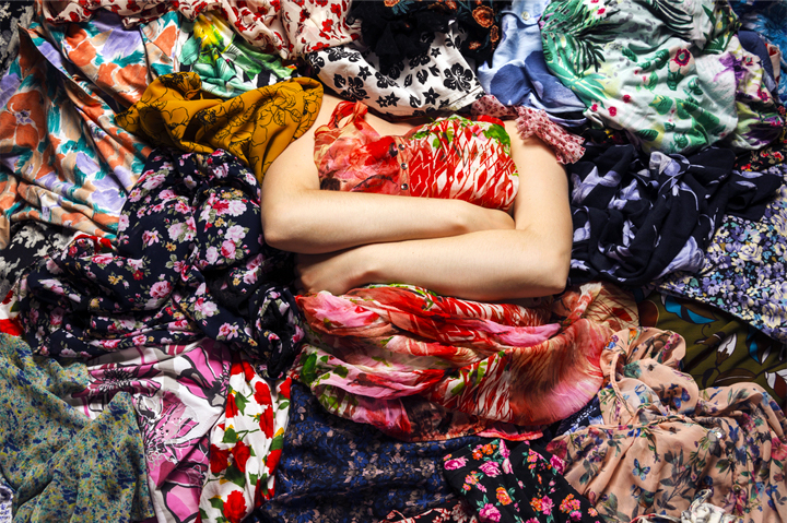 woman draped in colorful printed fabrics