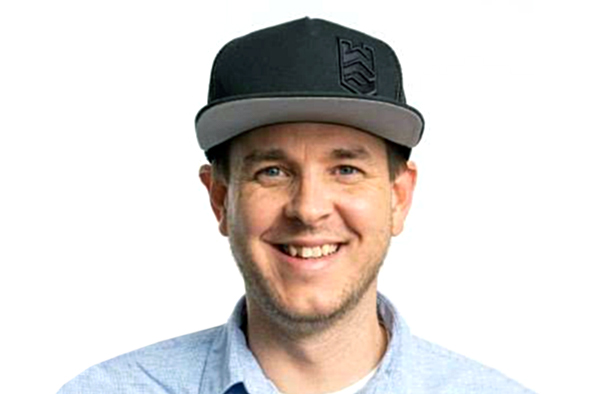 Jason Phalen smiling wearing blue shirt and black cap