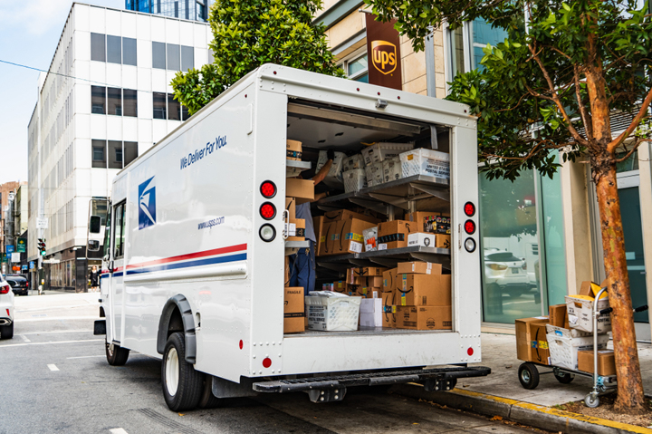 USPS mail truck open, packages inside