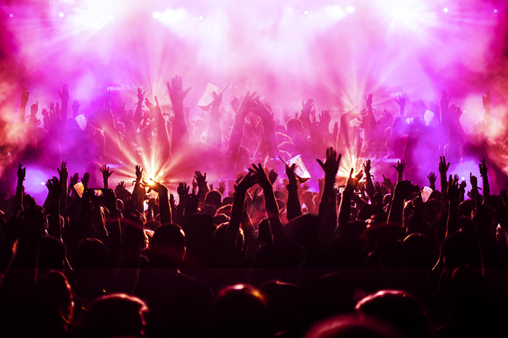 music festival stage and fans waving arms