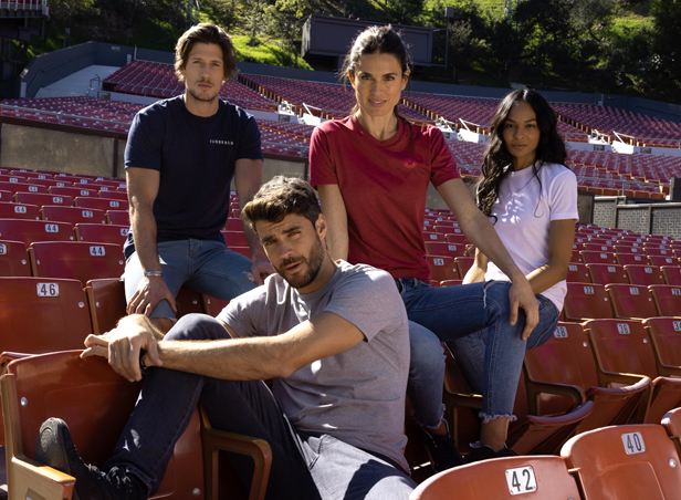 people sitting and standing on stadium seats