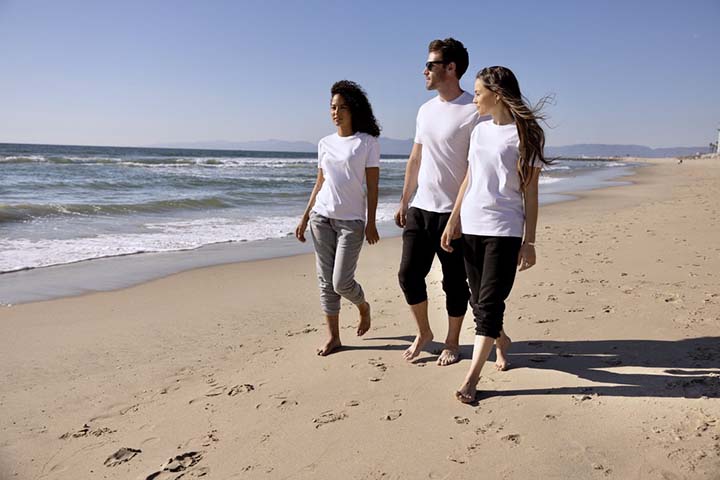 Young people on the beach in white T-shirts