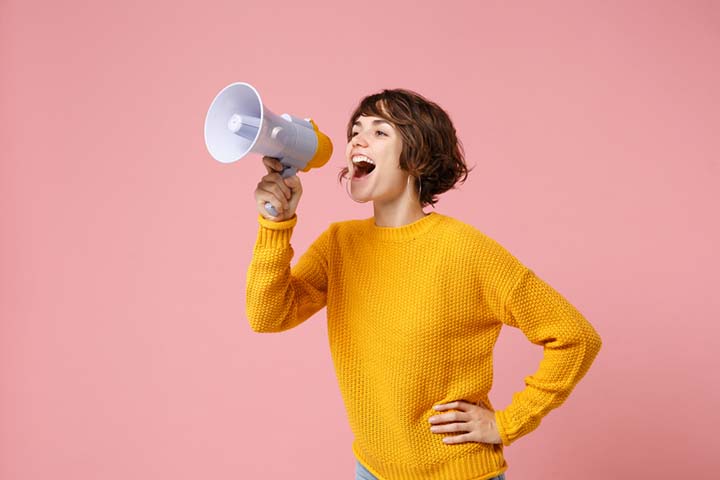 Young woman yelling on a megaphone