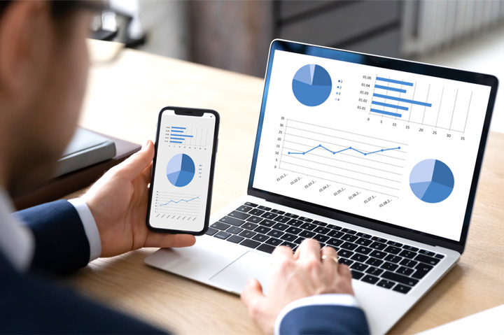 financials, charts, data on computer and smartphone