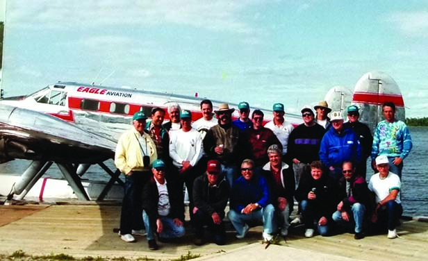 Fred Oesen and large group standing in front of plane