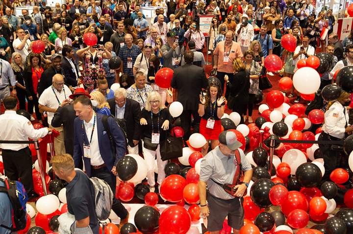 ASI Show floor opening day, red, white and black balloons