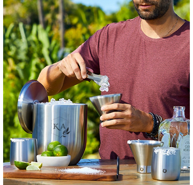 man making a cocktail using metal barware