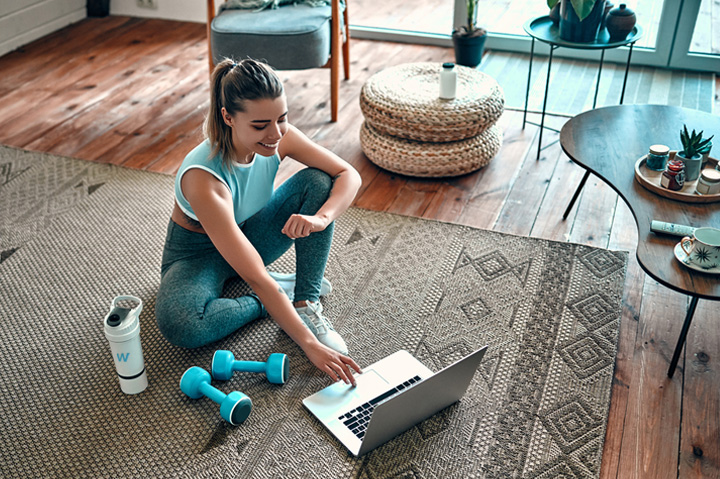 fitness woman on floor using laptop