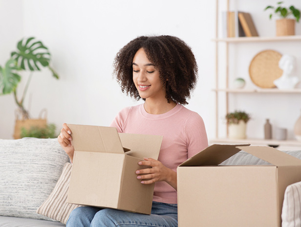woman unboxing a package, smiling