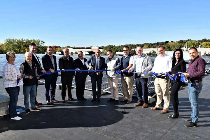 ribbon cutting ceremony, solar panels in background