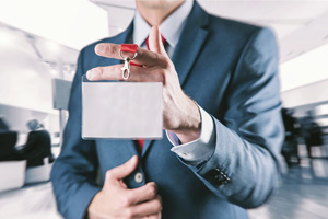 businessman holding trade show lanyard