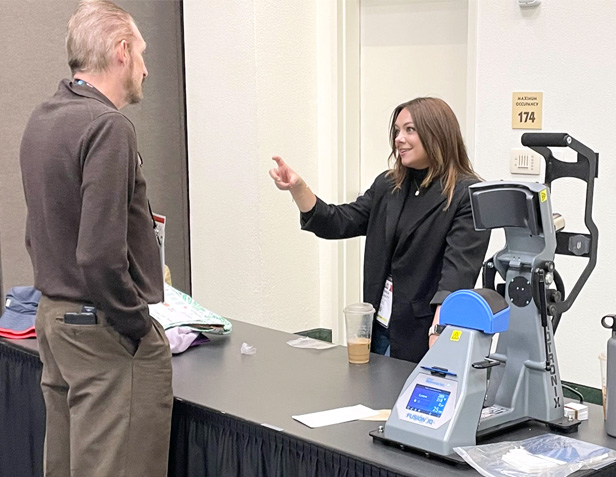 woman talking to trade show attendee