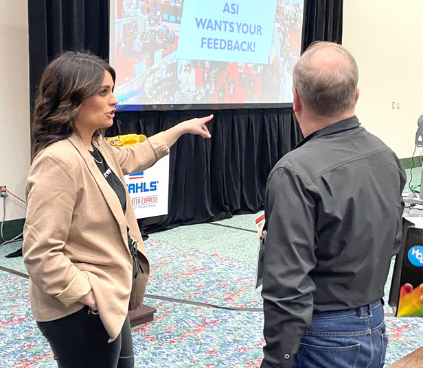 woman talking to trade show attendee