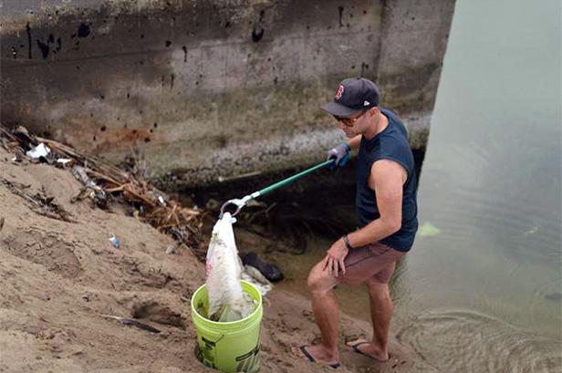 man cleaning up plastic bags