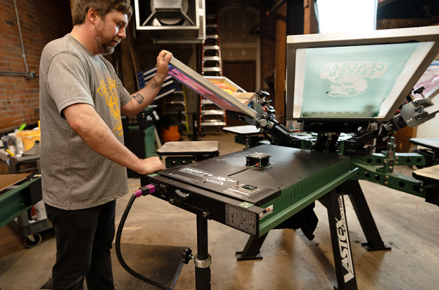 man screen printing t-shirt