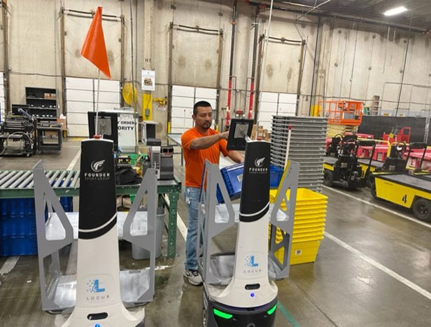 man operating robot in warehouse