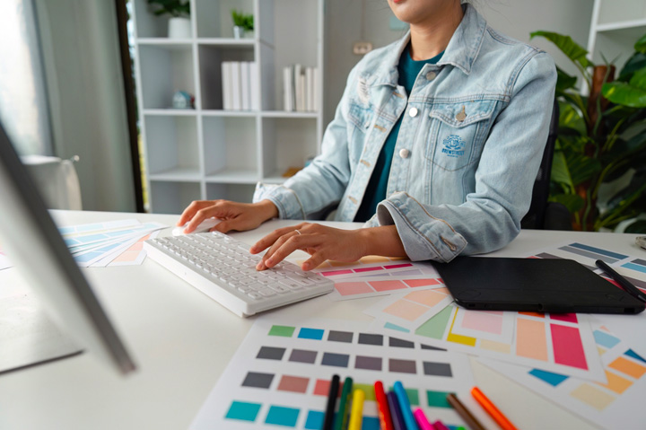 graphic designer sitting at laptop