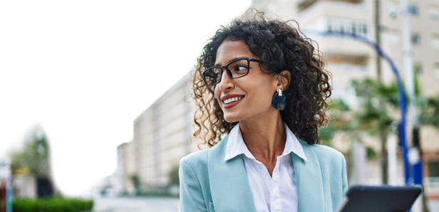 smiling female professional with glasses and blue blazer