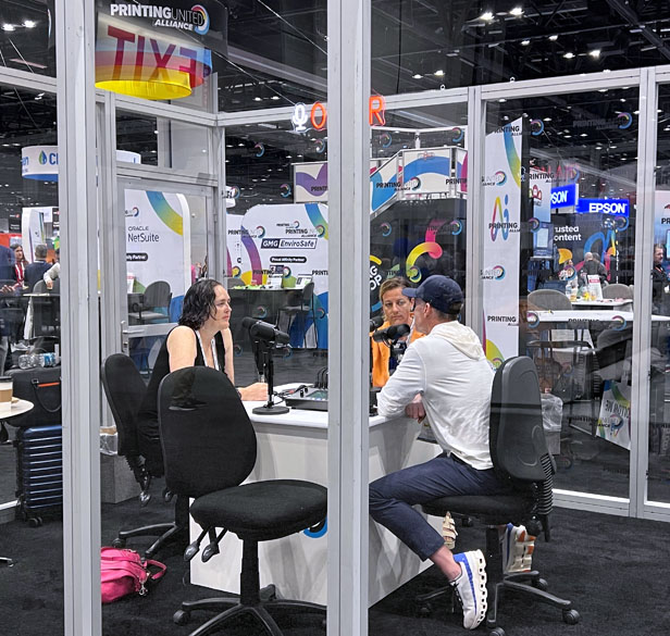 three people in a podcast studio at a tradeshow