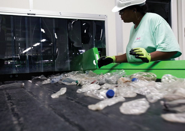 woman working in plastic bottle recycling plant