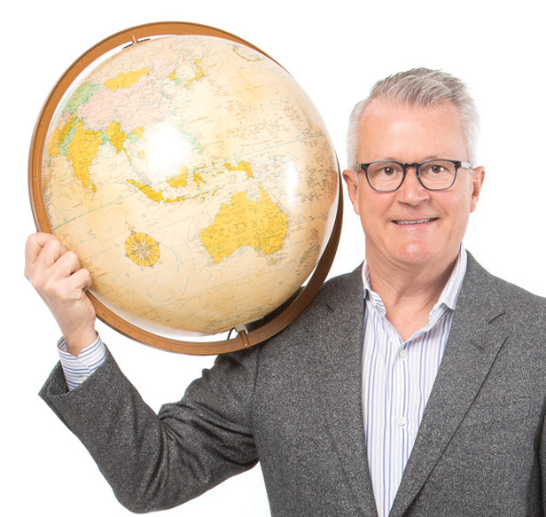 Tim Andrews holding a globe on his right shoulder