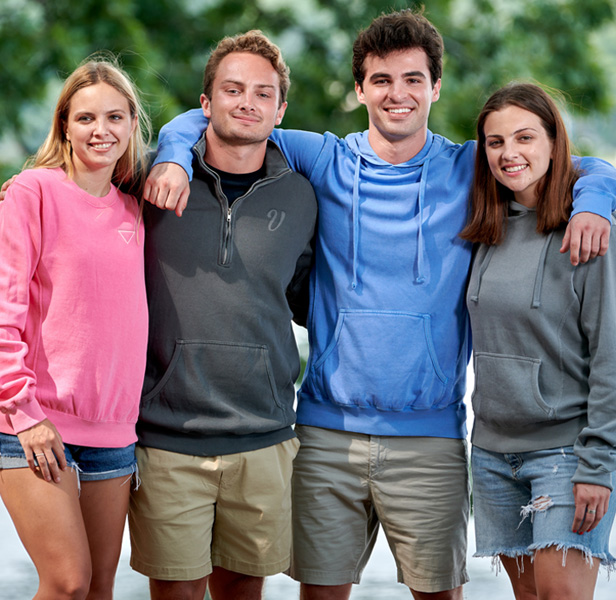 group of young people wearing colorful sweatshirts