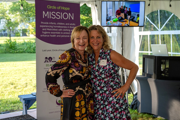 two women hugging and smiling at camera