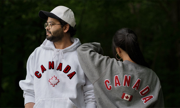 man and woman wearing Canada sweatshirts