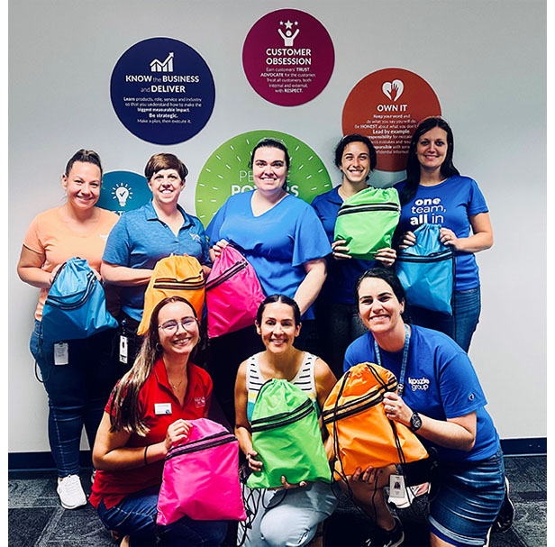 group of women holding drawstring backpacks